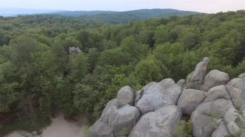 Flying through the spectacular mountain landscape of Duvbush rocks in the forest Stock Footage 219721315