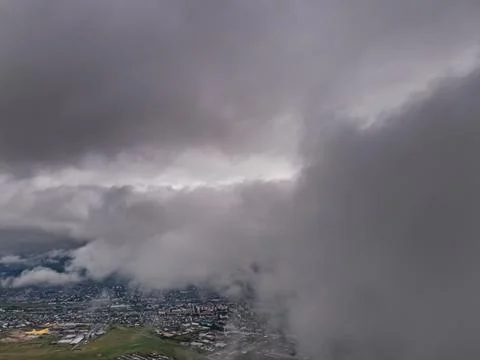 Flying through thick clouds. Rain clouds in the sky. Cumulus clouds, meteorol Stock Photos