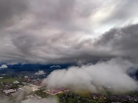 Flying through thick clouds. Rain clouds in the sky. Cumulus clouds, meteorol Stock Photos