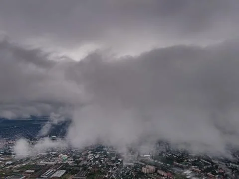 Flying through thick clouds. Rain clouds in the sky. Cumulus clouds, meteorol Stock Photos