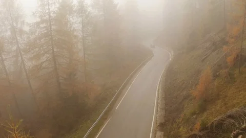 Flying through thick clouds on a road wit a car in a cloudy day  in Autumn Stock-Footage 129827757