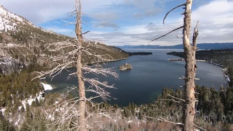Flying through tree gap in Emerald Bay Stock Footage 98367407