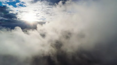 Flying through white fluffy clouds towards bright shining sun. Stock Footage 150891600