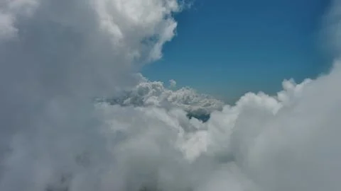 Flying through white fluffy clouds Stock Photos