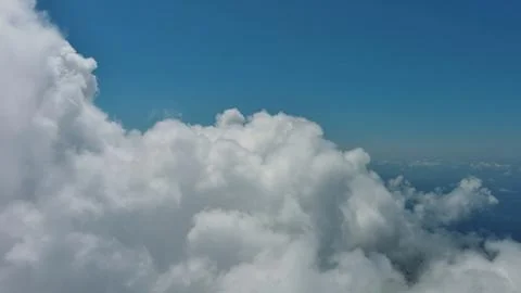 Flying through white fluffy clouds Stock Photos