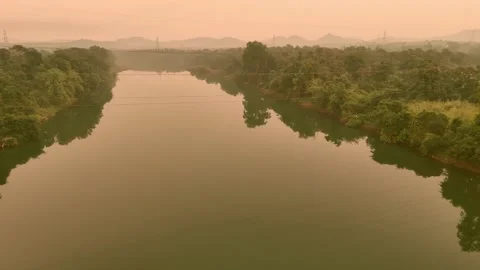 Flying thru HT lines over river Stock Footage 320063905
