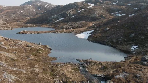Flying Top Down Over a Small Wide Waterfall In Lofoten Stock Footage 116393102