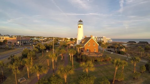 Flying up toward and beside a lighthouse with sun to our back. Stock Footage 90560742