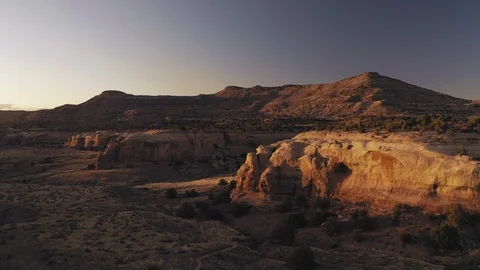 Flying toward golden sandstone cliffs at sunset in western Colorado Stock Footage 127463339