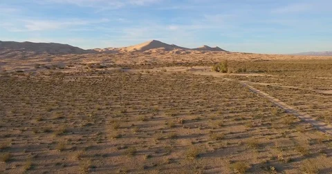Flying toward Mt. Kelso sand dunes in Mojave National Preserve at sunset Video stock 73527435