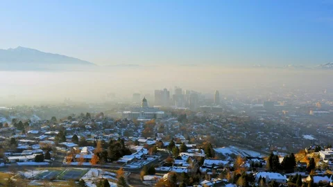Flying toward Salt Lake City Capitol and Downtown on smoggy winter morning Stock Footage