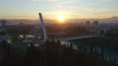 Flying toward the silhouette of Millennium, cable-stayed bridge on Moraca Stock Footage 135604375