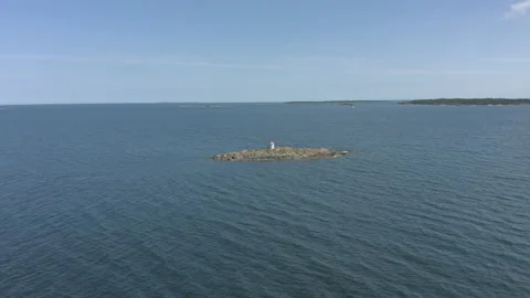 Flying toward small washed lighthouse on a remote island Stock Footage 134178299