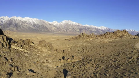 Flying toward the snow capped Eastern Sierras at sunrise. Stock Footage 155578270