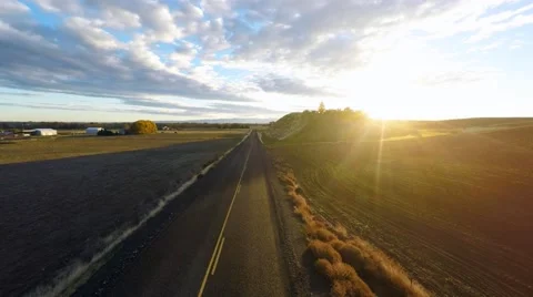 Flying toward the sunrise over fields Stock Footage 43623049
