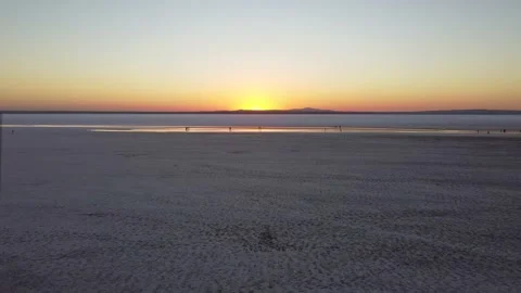 Flying toward sunset over a flat salt lake Tuz in Turkey Stock Footage 169477143