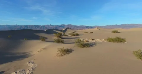 Flying toward top of Mesquite Flat Sand Dunes in Death Valley, California Stock Footage 64330624
