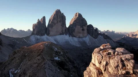 Flying toward Tre Cime di Lavaredo close past cliffs at sunrise Stock Footage 341151498