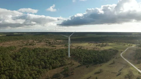 Flying toward a wind turbine in a forest rural area, aerial drone footage Stock Footage 149151024