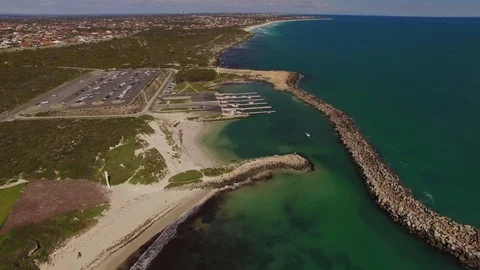 Flying towards boats loading at an ocean marina Stock Footage 94454520