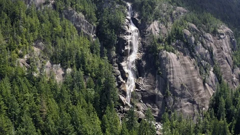 Flying towards a cascading waterfall on cliff face Stock Footage 111950542