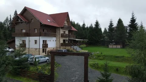 Flying towards a chalet in the mountains Stock Footage 260207505