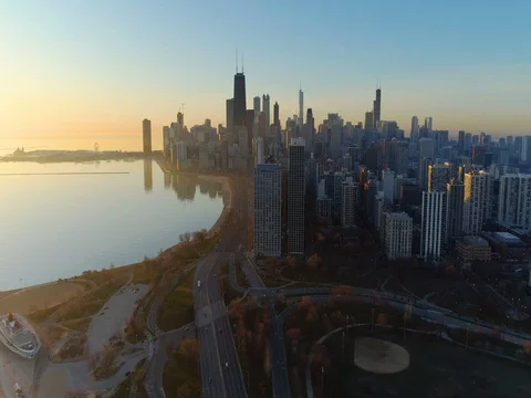 Flying towards Chicago Downtown Skyscrapers with sunrise morning light. Stock Footage