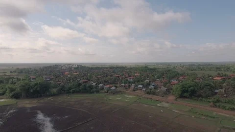  flying towards an earth path passing through a typical south-east Asian village Stock Footage 99484139