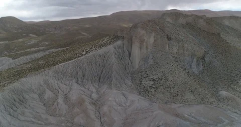 Flying towards eroded mountain slope to senital of strange erosion formations 스톡 동영상 103494685