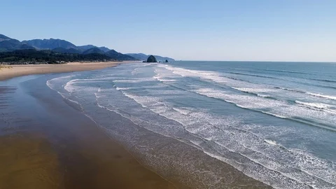 Flying Towards Haystack Rock over Waves Stock Footage 124714195