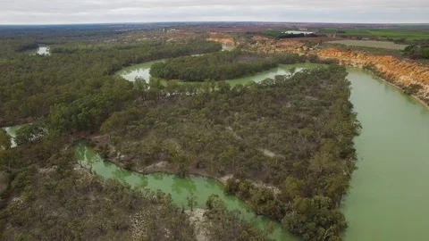 Flying towards Murray River bend over native vegetation in South Australia Stock Footage 93240580