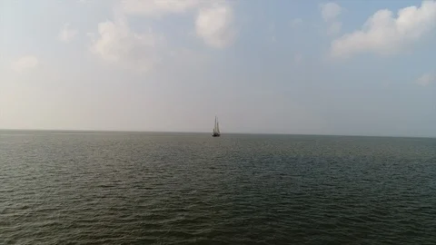 Flying towards old big sailing ship long distance on sea - Aerial Stock-Footage 103353566