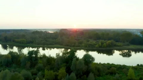Flying towards the rays of the rising sun over the Bug riverbed Stock Footage 161810448