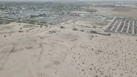 Flying towards a salvage yard in a small Arizona town Stock Footage 192577500