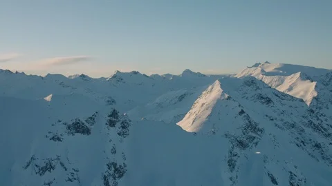 Flying towards sharp mountain ridges during sunrise Stock Footage 101915255