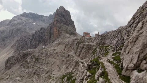 Flying towards small refuge in the middle of the mountains Stock Footage 224543245