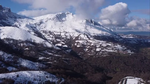 Flying towards a snow-capped mountain surrounded by clouds. Aramo. Asturias Video stock 152445330