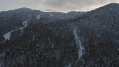 Flying towards the snow dusted peak of a retired ski mountain AERIAL 動画素材 122690969