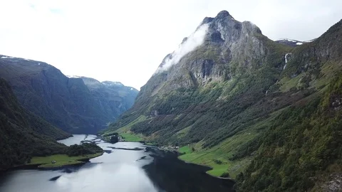 Flying towards a Stream Falling off a Hanging Valley into Nærøyfjord Stock Footage 81494191