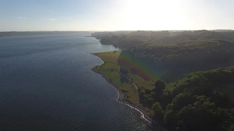 Flying Towards Sun Water Reflection 4K Shore Beach Ocean Nature Drone Footage Stock Footage 115411240