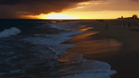 Flying towards sunset along waves and shoreline, aerial above Kauai, Hawaii Stock Footage 108353049