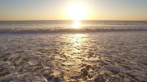 Flying towards sunset over ocean waves 스톡 동영상 71196064