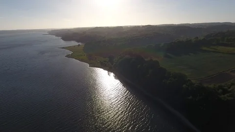 Flying Towards Sunshine with Water Reflection 4K Areal Drone Nature Ocean Stock Footage 115413627