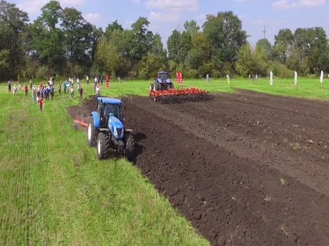 Flying Towards Tractor Plowing Field Stock Footage 73717439