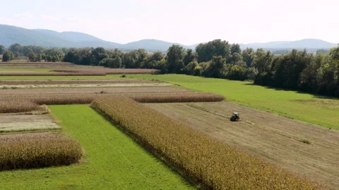 Flying towards tractor working the fields on a sunny day. Stock Footage 285773178