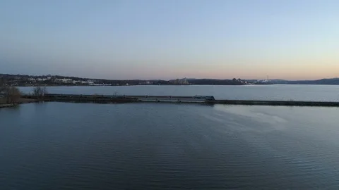 Flying Towards Train Passing on Tracks Over the Hudson River at Sunset Stock Footage 94687883