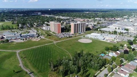 Flying Towards Two Large Apartment Buildings By Baseball Diamond And Highsch Stock Footage 123011019