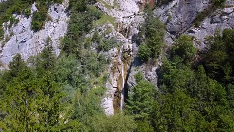 Flying towards a waterfall in the mountains. Video stock 151924302