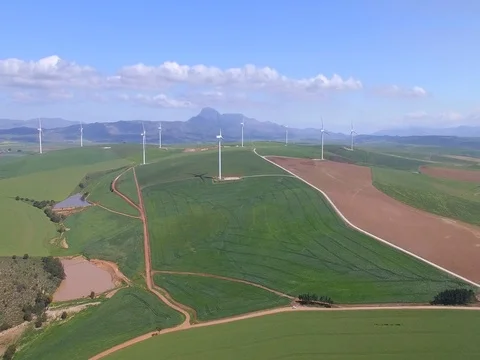 Flying Towards Wind Farm in Green Field with Blue Skies Stock Footage 79100923