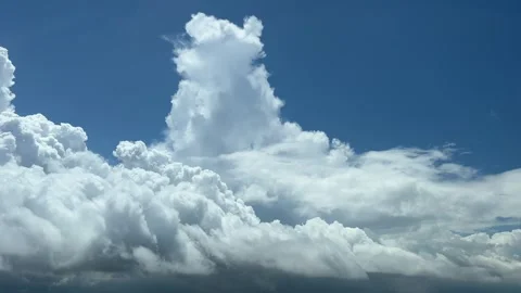 Flying troguh a cloudy sky with some tiny cumulus. A pilot’s perpective. Stock Footage 243340231